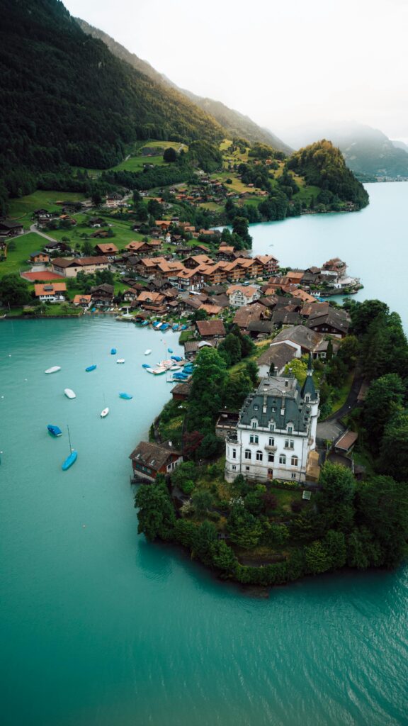Stunning aerial photograph of Iseltwald village on Lake Brienz, Switzerland during summer.