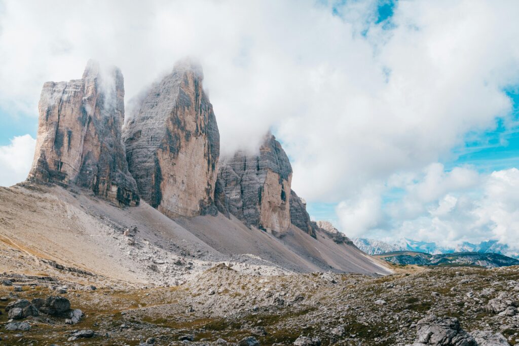 Stunning view of the Tre Cime di Lavaredo peaks under clouds in the Dolomites, Italy.