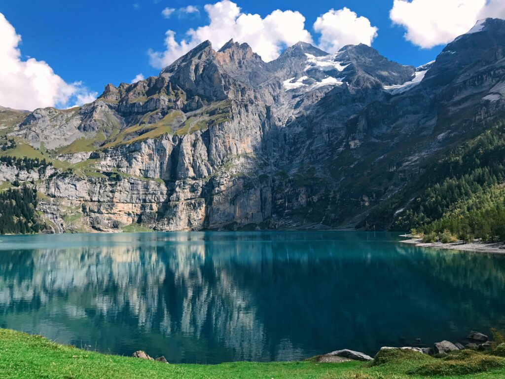 Stunning view of the Swiss Alps and a serene lake in Kandersteg, perfect for travel and nature enthusiasts.